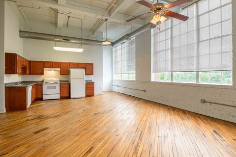 A room with wooden floors and a ceiling fan.