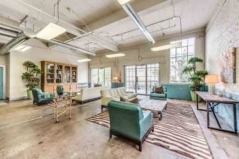 A spacious living room with a variety of seating options and a large window.