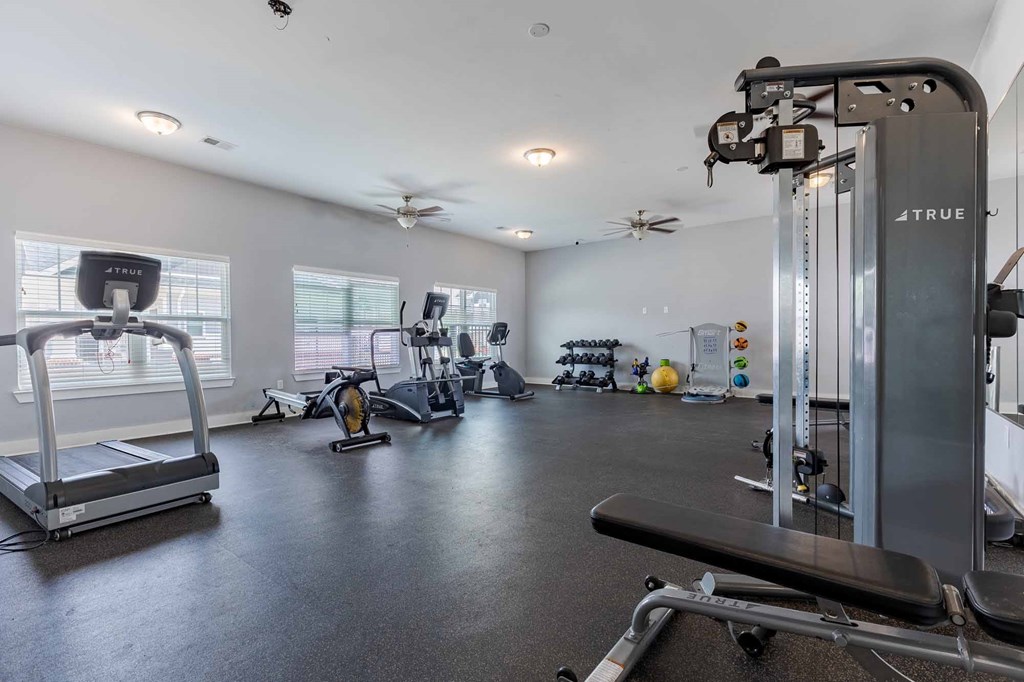 A well-equipped gym with treadmills, elliptical machines, and other exercise equipment.