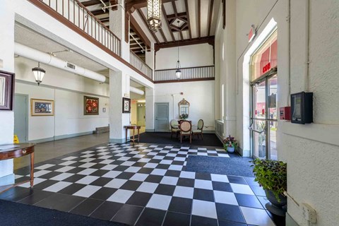 A black and white checkered floor in a spacious room.
