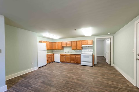 A kitchen with wooden cabinets and white appliances.