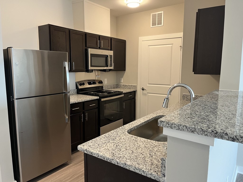 Kitchen with a granite counter top and stainless steel appliances at James Lewis Jr, Charleston, SC