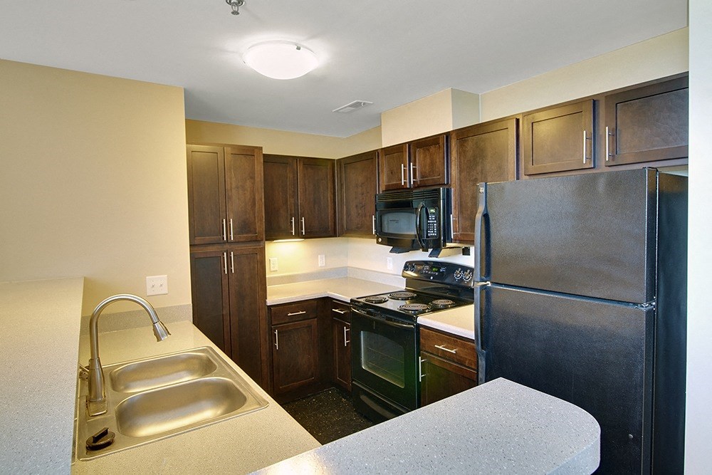 a kitchen with stainless steel appliances and wooden cabinets