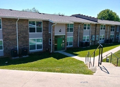 a row of brick apartment buildings with stairs