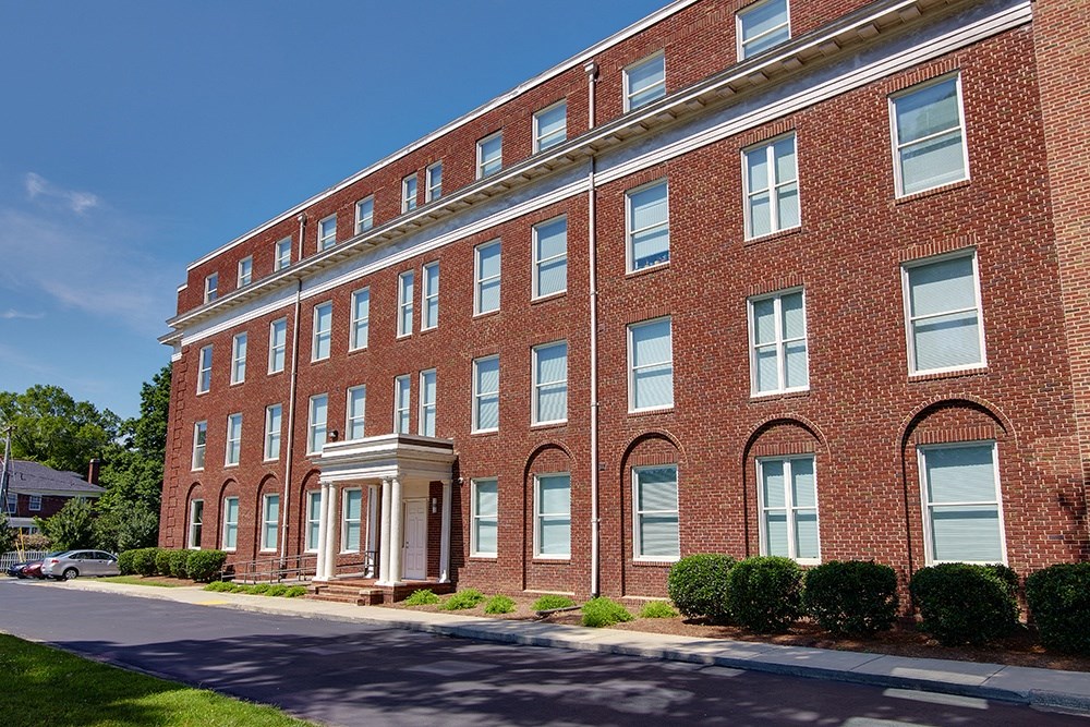 a large brick building on the side of a street