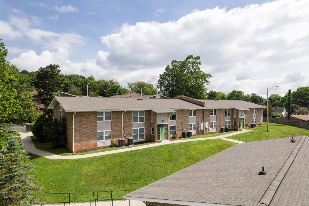 Apartment complex with a green lawn in front.