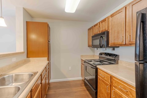 A kitchen with wooden cabinets and stainless steel appliances.