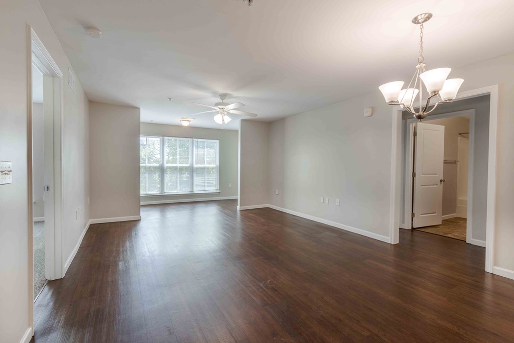 A spacious room with wooden floors and a ceiling fan.at Marsh View Place, Charleston, SC 29455
