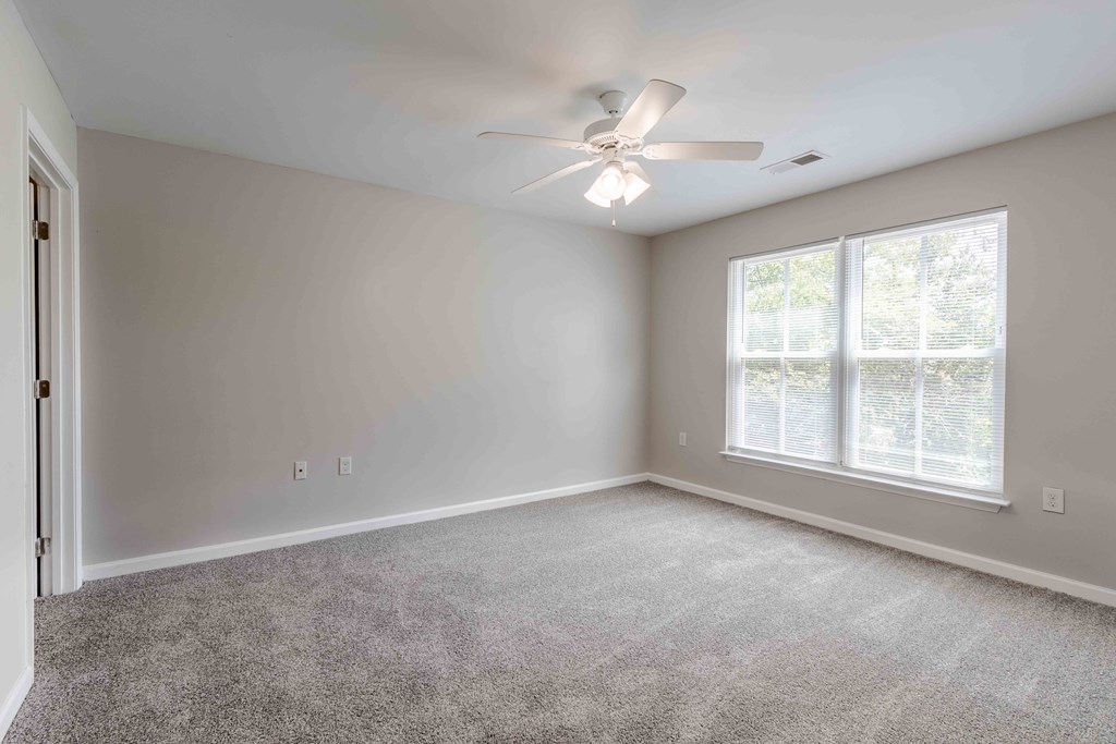 A room with a ceiling fan and a window with blinds.at Marsh View Place, Charleston, 29455