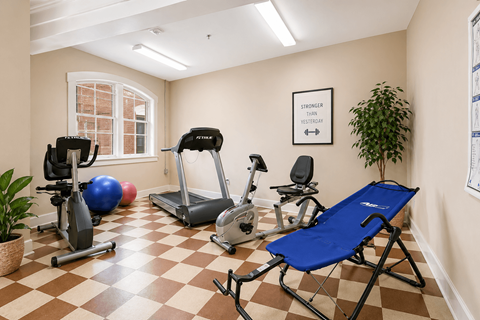 A room with exercise equipment and a blue folding chair.