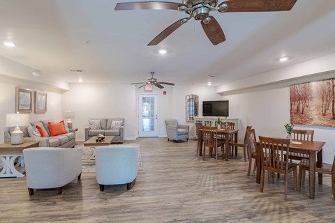 A spacious living room with a dining table and chairs.