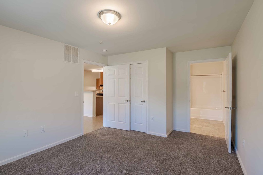A room with a carpeted floor and white walls. at Mountain Laurel III Apartments, Staunton
