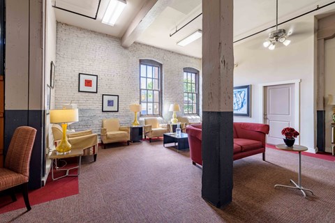 A living room with a red carpet and a red couch.