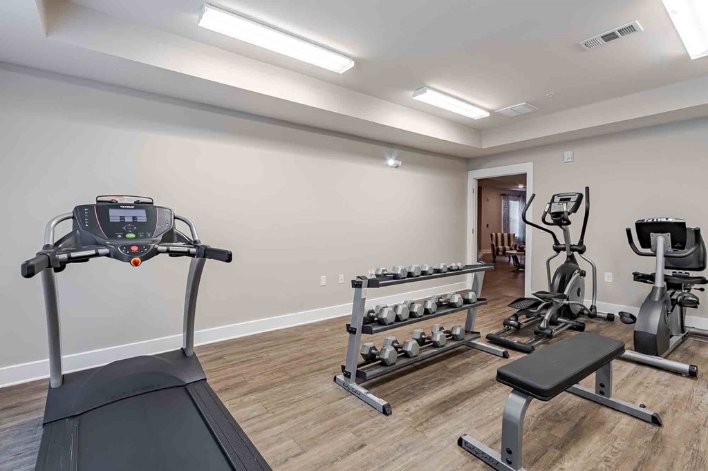 Gym with cardio machines and weights at Oakside Apartments, South Carolina, 29455