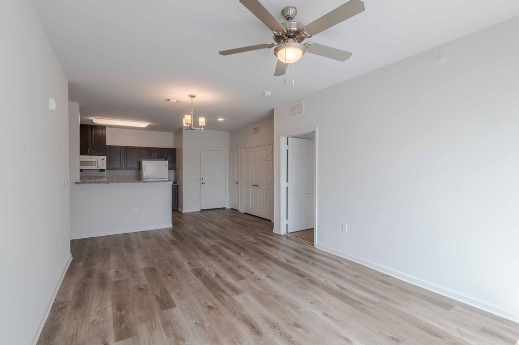 A room with a ceiling fan and light fixture.