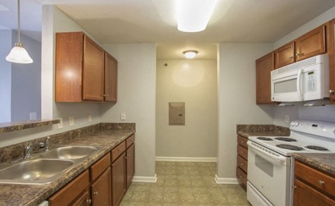 a kitchen with a stove microwave and sink