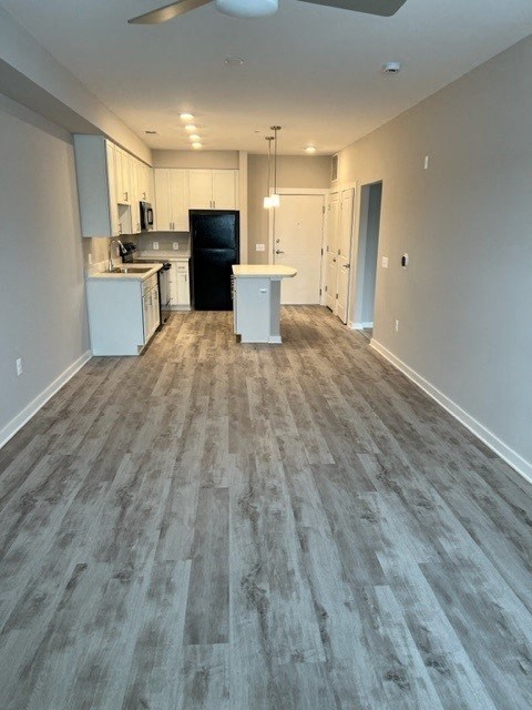 a empty living room and kitchen with a wood floor