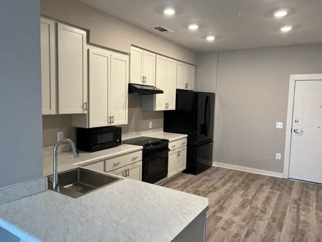 a kitchen with white cabinets and a sink