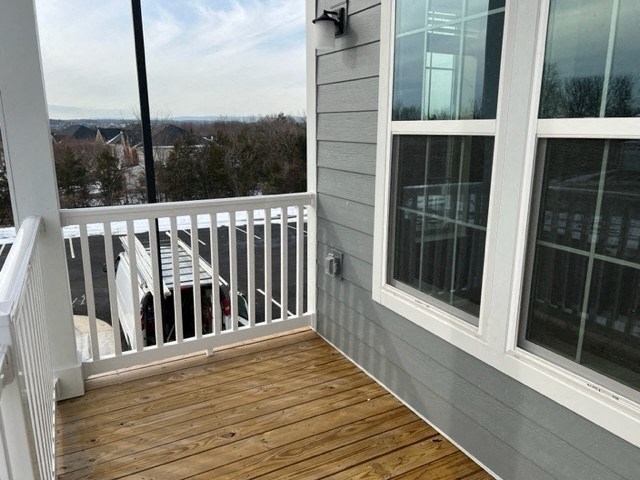 a porch with a view of a house and a deck