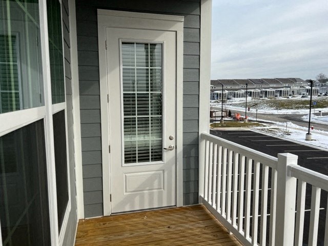 a white door on the side of a house with a porch