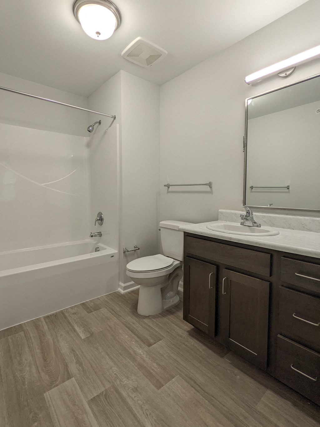 a bathroom with a mirror and a toilet and a sink