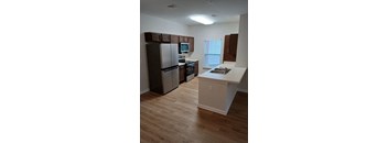 Kitchen with wooden floors and a white counter at The Assembly II in 29611