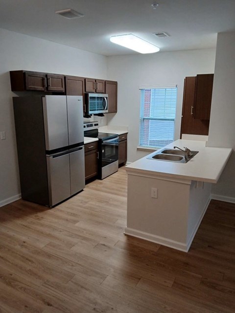 a kitchen with stainless steel appliances and a sink