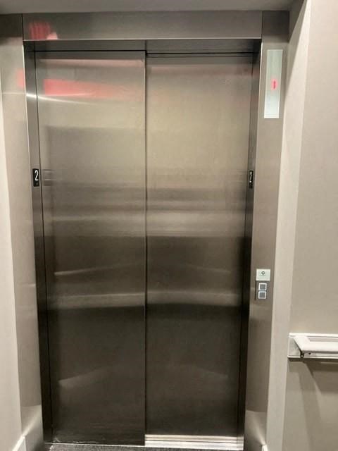 a stainless steel elevator with two doors