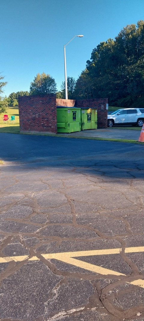 A white car is parked in a parking lot.