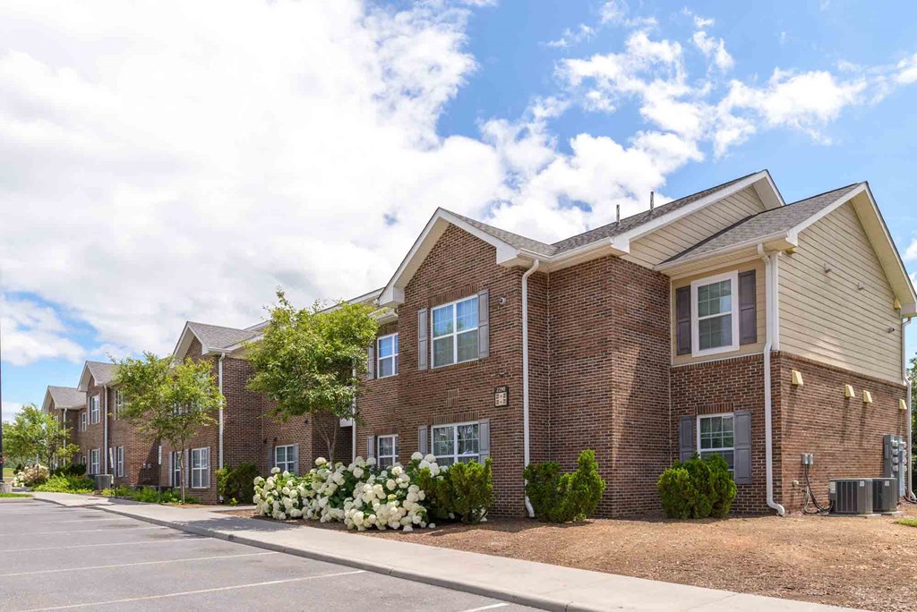 A row of houses with a parking lot in front at Robinson Park Apartments, Harrisonburg, Virginia