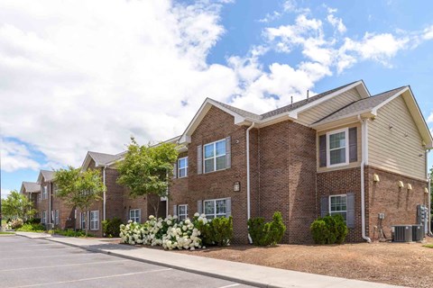 A row of houses with a parking lot in front at Robinson Park Apartments, Harrisonburg, Virginia