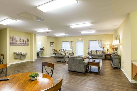 A living room with a wooden table and chairs.