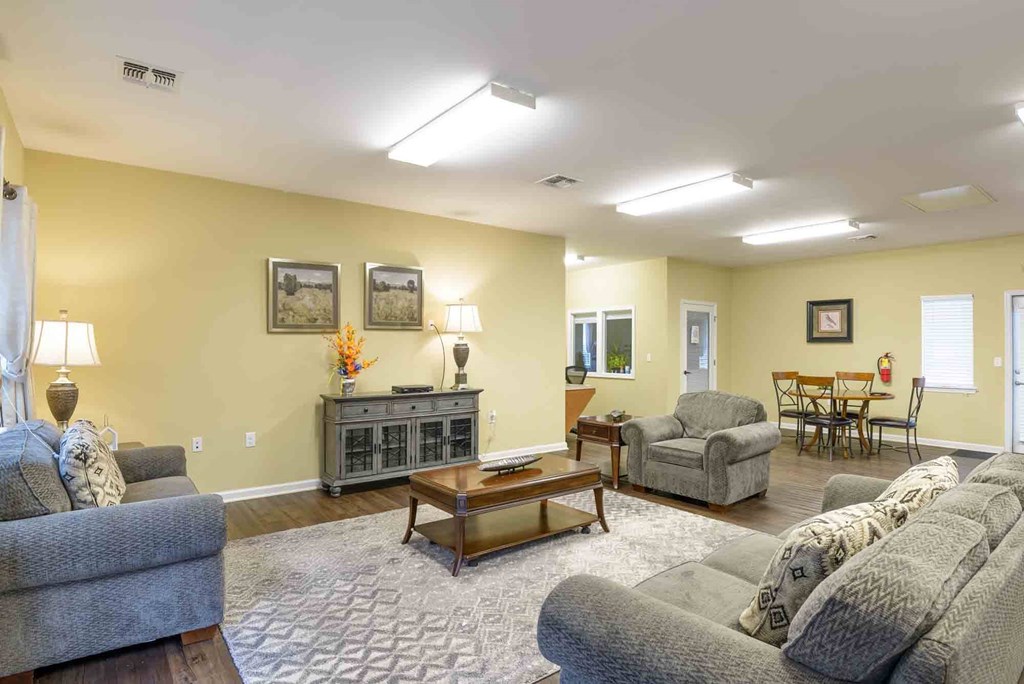 A living room with a grey sofa, a wooden coffee table, and a grey couch at Robinson Park Apartments, Virginia