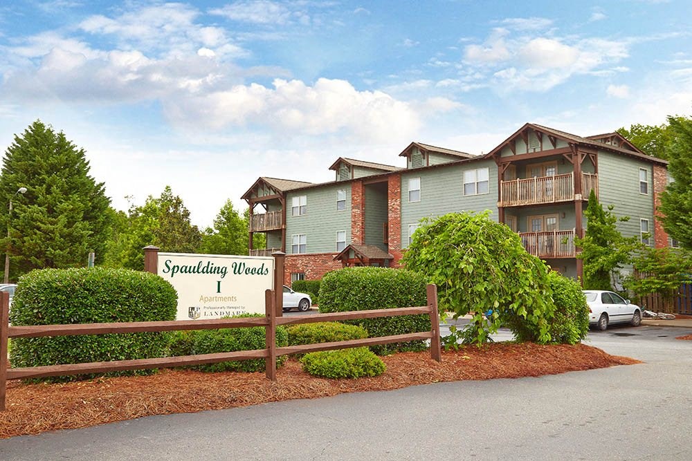 an apartment building with a street sign in front
