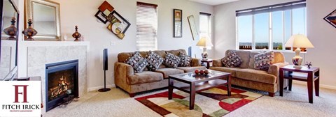 A living room with a fireplace and a couch.