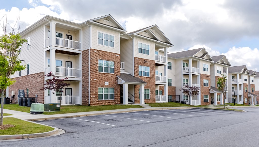 Apartment buildings with a mix of brick and siding exteriors.