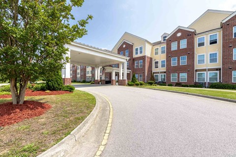A large apartment complex with a curved driveway in front at The Grande at Granite Falls LLC Apartments, Rolesville, NC