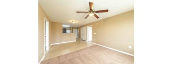 A spacious room with a ceiling fan and carpeted floor. at The Grande at Granite Falls LLC Apartments, Rolesville