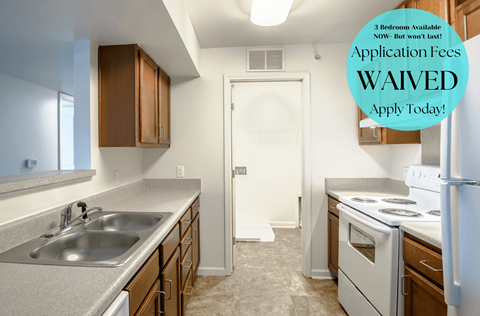A kitchen with a sign that says "Application Fees WAIVED".