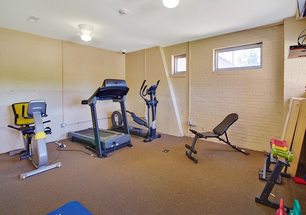 the gym with plenty of exercise equipment at our apartments