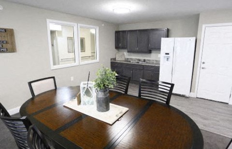 a kitchen and dining room with a table and chairs