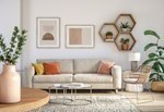 A living room with a white sofa, a wooden table, and a rug.