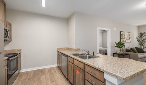 A kitchen with a granite countertop and stainless steel appliances.