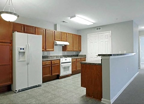 a kitchen with white appliances and wooden cabinets