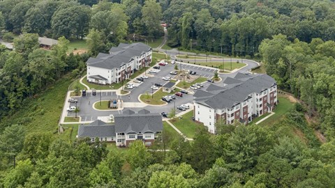 an aerial view of a parking lot and several buildings