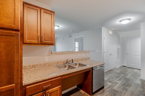 A kitchen with wooden cabinets and a granite countertop.