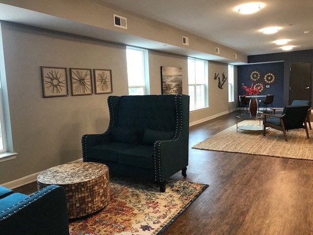 a living room with blue chairs and a table