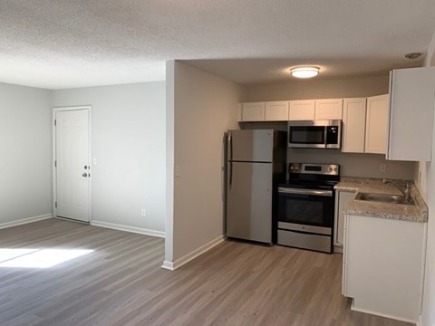 A kitchen with a refrigerator, oven, and microwave.at Summerville Garden, Summerville