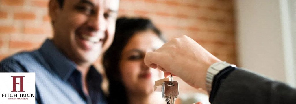 A person is handing over a key to another person. at Coit Village Apartments, Florence, SC