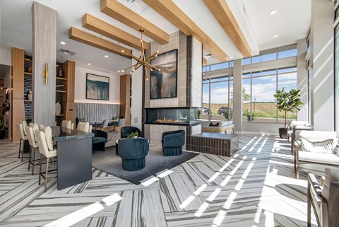 A modern living room with a fireplace and a large painting above it.